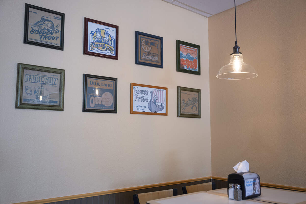 Cutouts from fruit boxes line the walls of The Original Hagen’s Orange Freeze new location in Fair Oaks on Monday, Aug. 17, 2026. Temme Hagen found the boxes at the original location, some of which date back to when the Merlino family owned the store.
